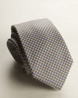 Beige Tie With A White And Blue Micro-Pattern In Silk
