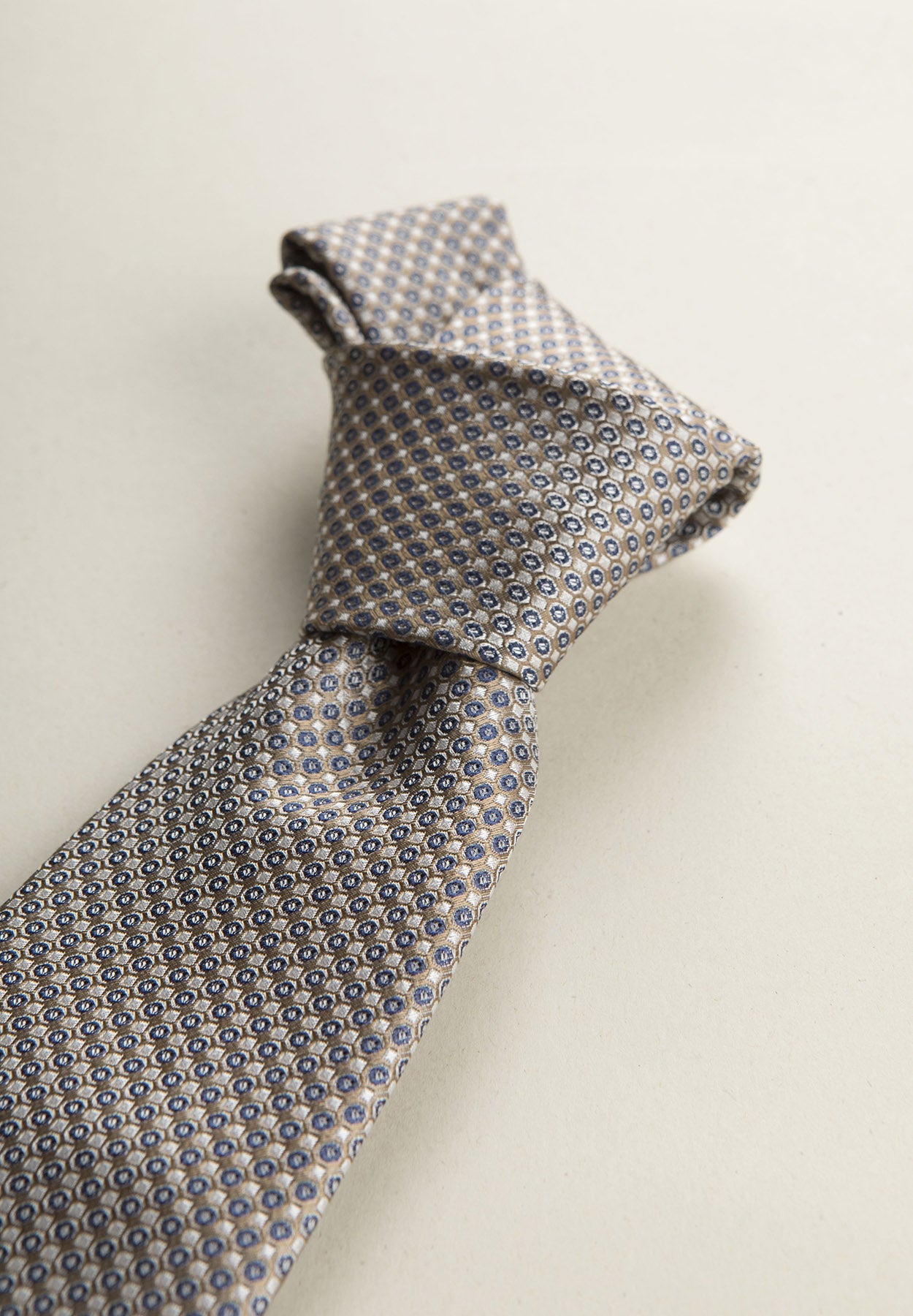 Beige Tie With A White And Blue Micro-Pattern In Silk
