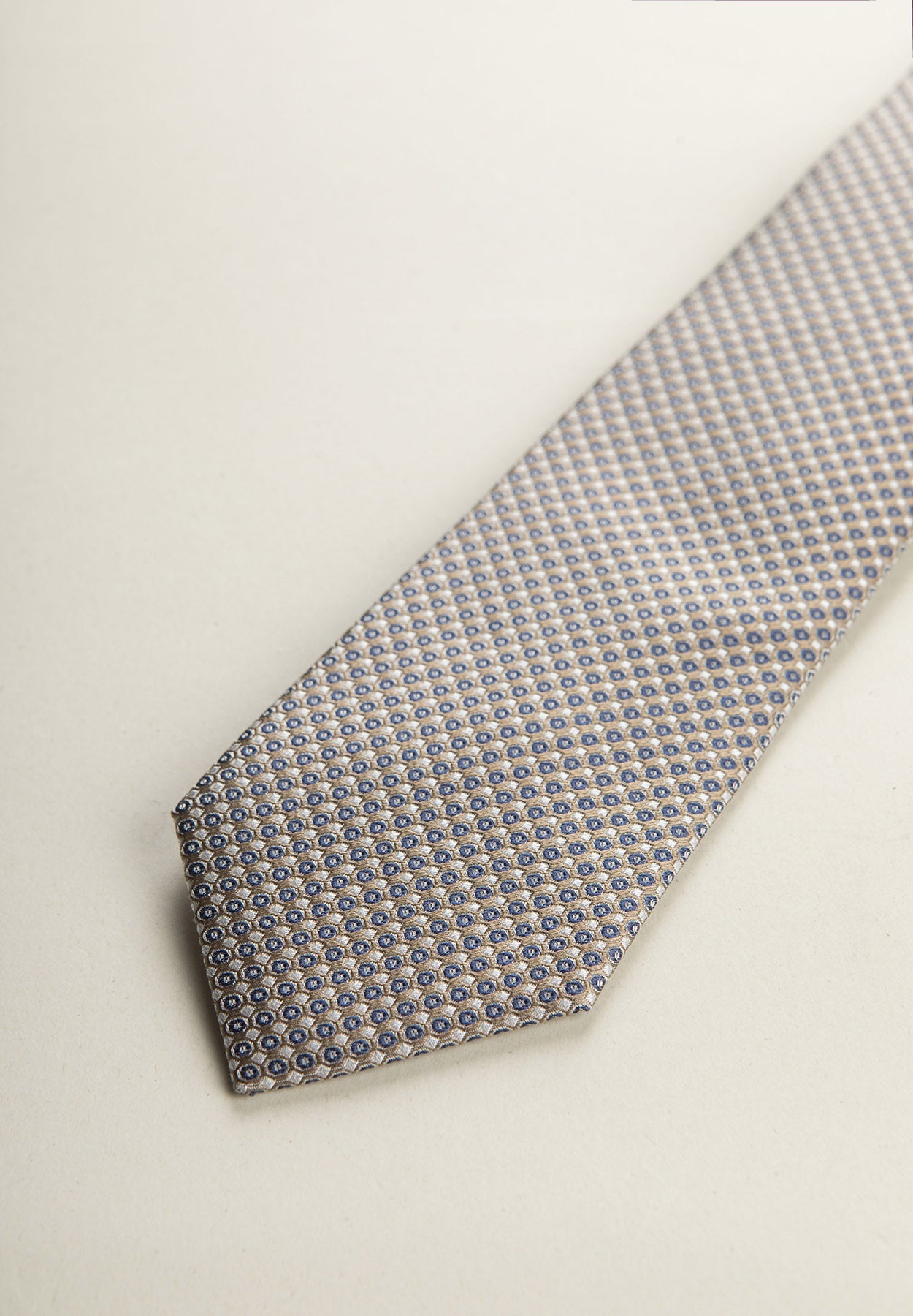 Beige Tie With A White And Blue Micro-Pattern In Silk