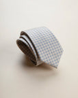 Beige tie with light blue floral pattern
