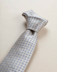 Beige tie with light blue floral pattern