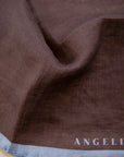 Dark brown clutch bag with light blue linen edge