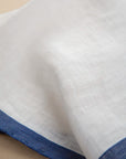White clutch bag with blue linen edge