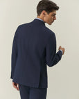Blue double-breasted suit with peak lapels and custom-fit stretch fabric