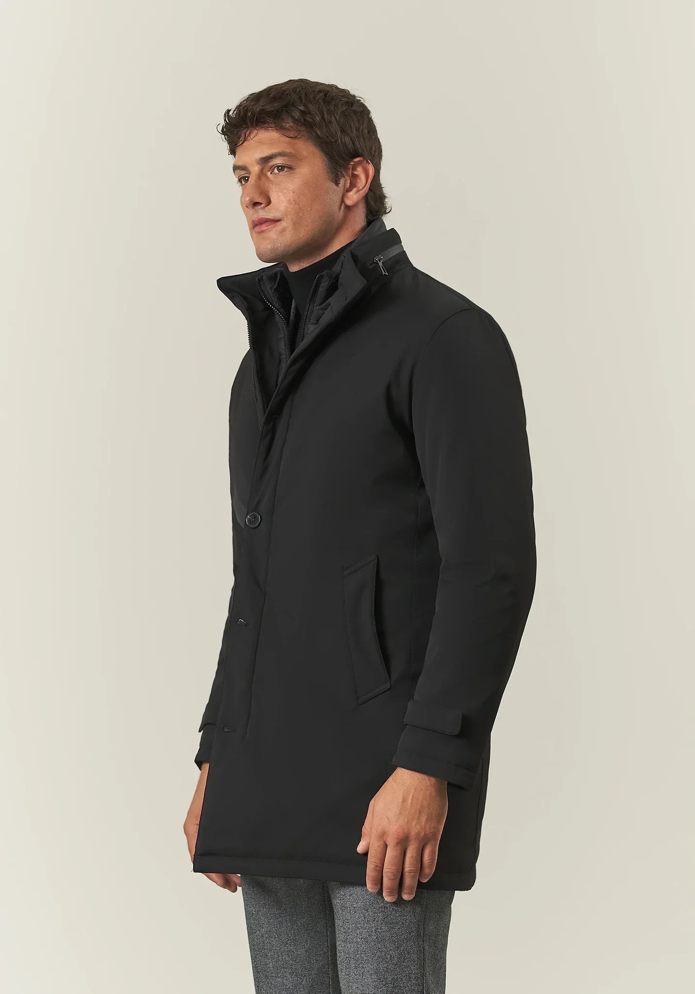 Black waterproof technical coat with detachable bib