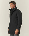 Black waterproof technical coat with detachable bib