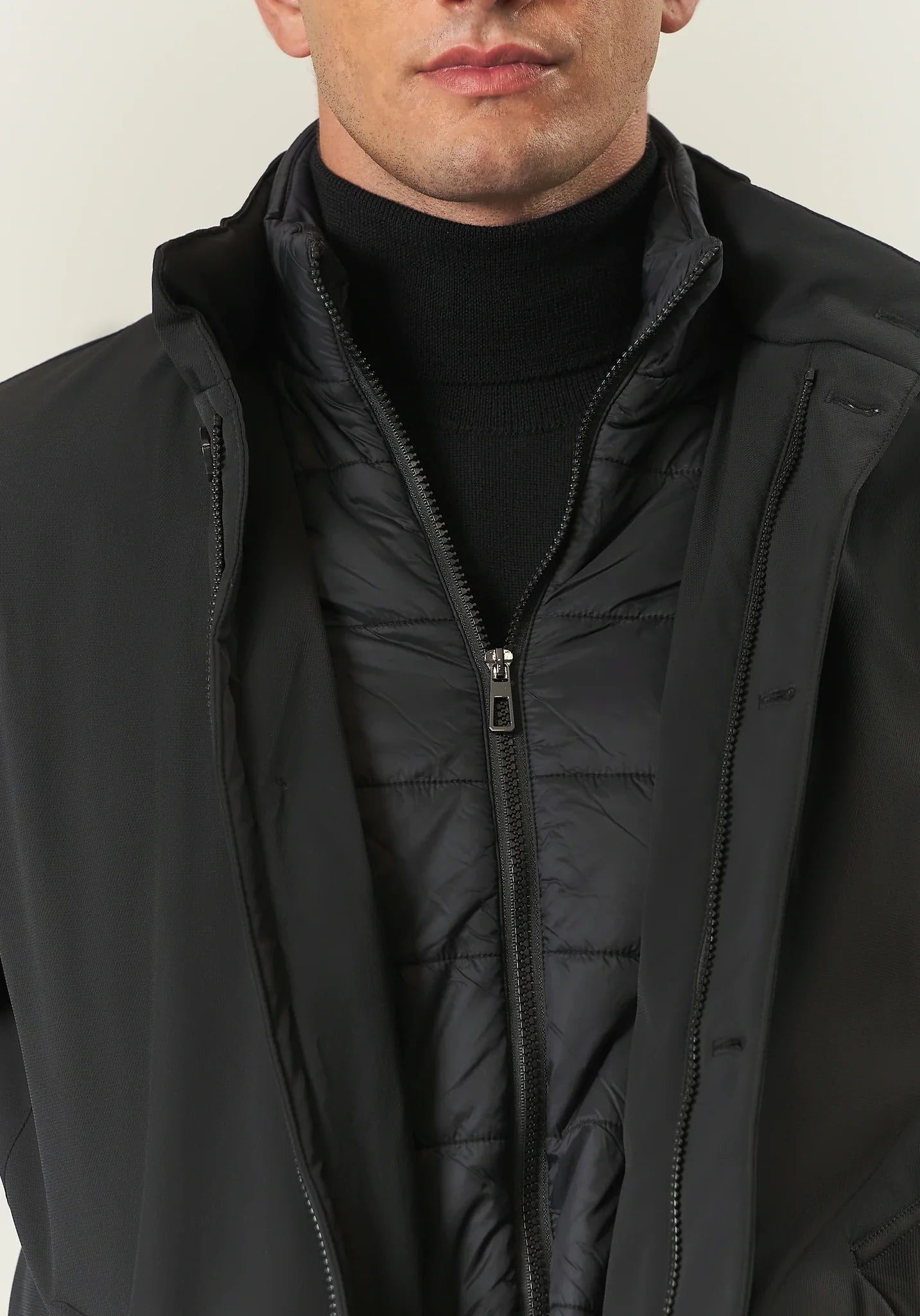 Black waterproof technical coat with detachable bib