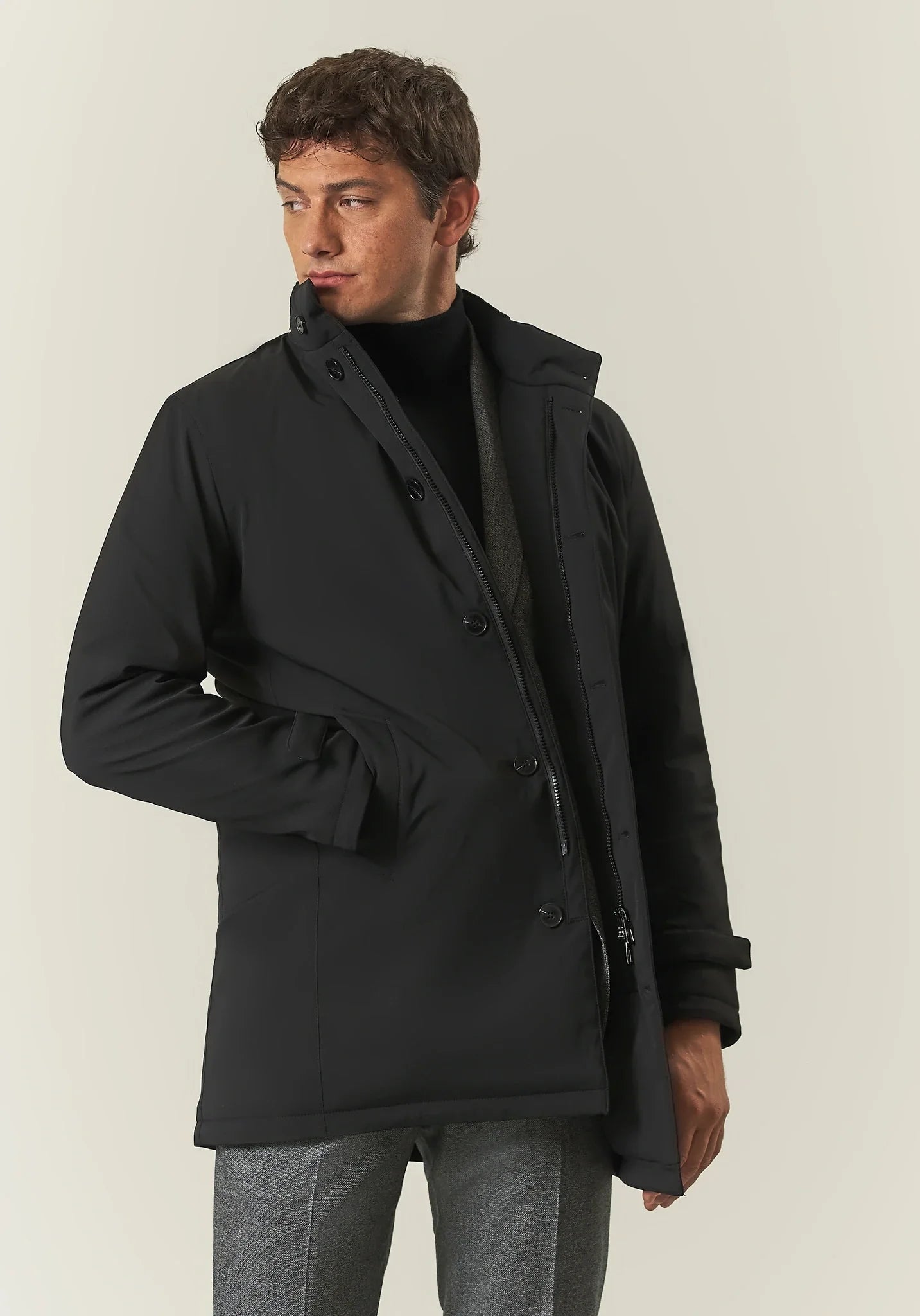 Black waterproof technical coat with detachable bib