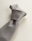Beige Tie With A White And Blue Micro-Pattern In Silk