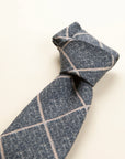 Light blue melange wool tie with checks