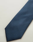 Blue tie with a white and light blue micro-pattern, silk