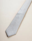 Beige tie with light blue floral pattern