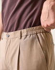 Beige trousers with half-elastic pleats