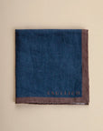 Blue clutch bag with dark brown linen edge