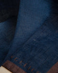 Blue clutch bag with dark brown linen edge