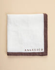 White clutch bag with dark brown linen edge