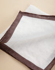 White clutch bag with dark brown linen edge